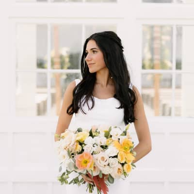 bride holding white and yellow bridal bouquet