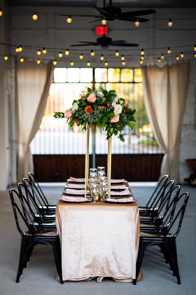 wedding reception table with tall floral arrangement