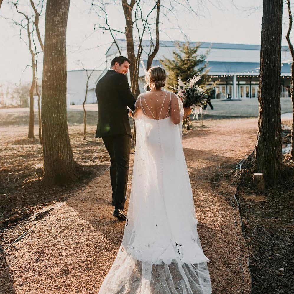 bride and groom walking outdoors during a sunset 